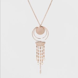 Rising sun gold tone pendant necklace